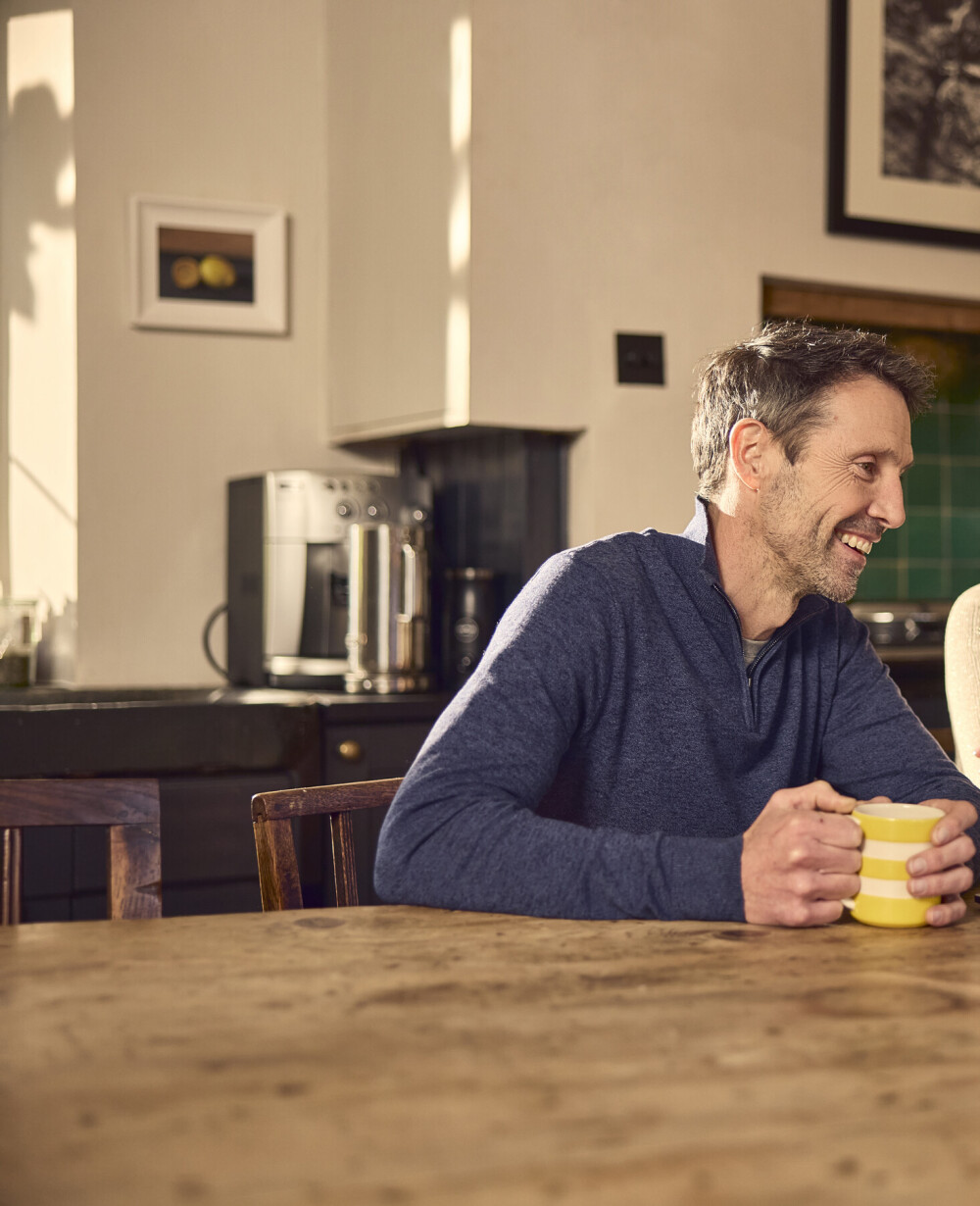 Happy couple smiling at the laptop with streaming internet